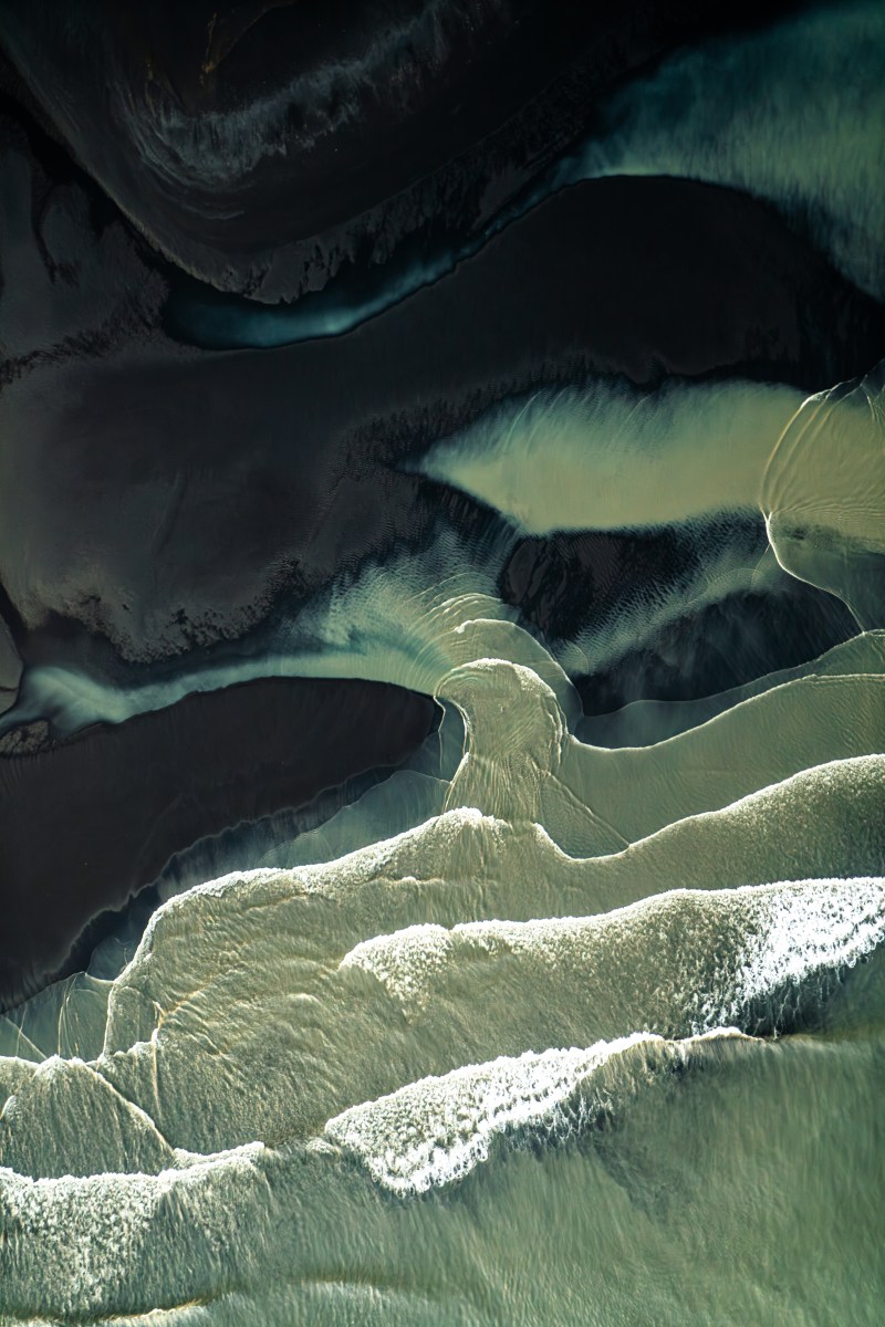 This is a photo of a glacial river mouth in Iceland in a town called Hofn. This is looking down from a small Cessna about 2,000 feet in the air and I'm shooting out the window as the plane is banking really hard to the right. I'm using a circular polarizer to cut through the reflection of the water and show those milky patterns. What you're seeing is all the glacial sediment that separates where the ocean meets the river. It's just an abstract perspective that I've loved over the years. I’ve found you have to get in the sky to showcase the unique perspectives of the sea and how it interacts with the land around it.