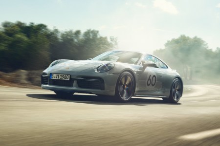A Porsche 911 with the number 60 painted on the side speeding down the road