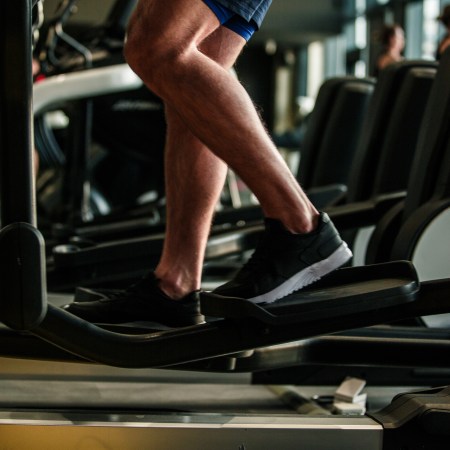 A man going backwards on an elliptical.