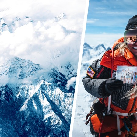 A photo of Jenn Drummond after she summited K2, holding a photo of her children.