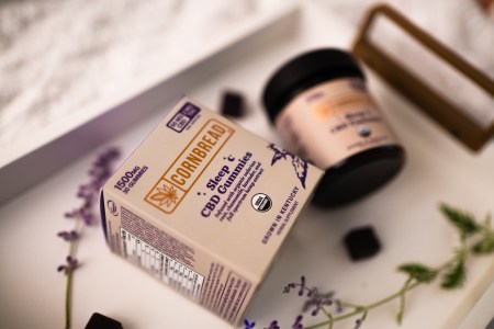 cornbread hemp cbd gummies on a white tray with lavender sprigs