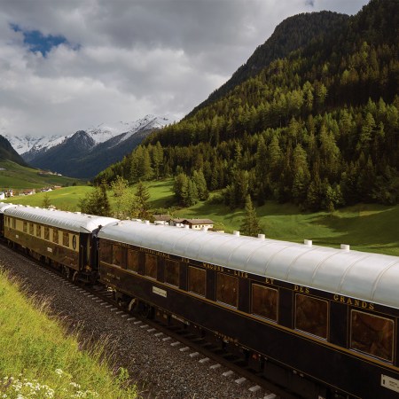 The Venice Simplon-Orient-Express, a Belmond Train, moving through the countryside