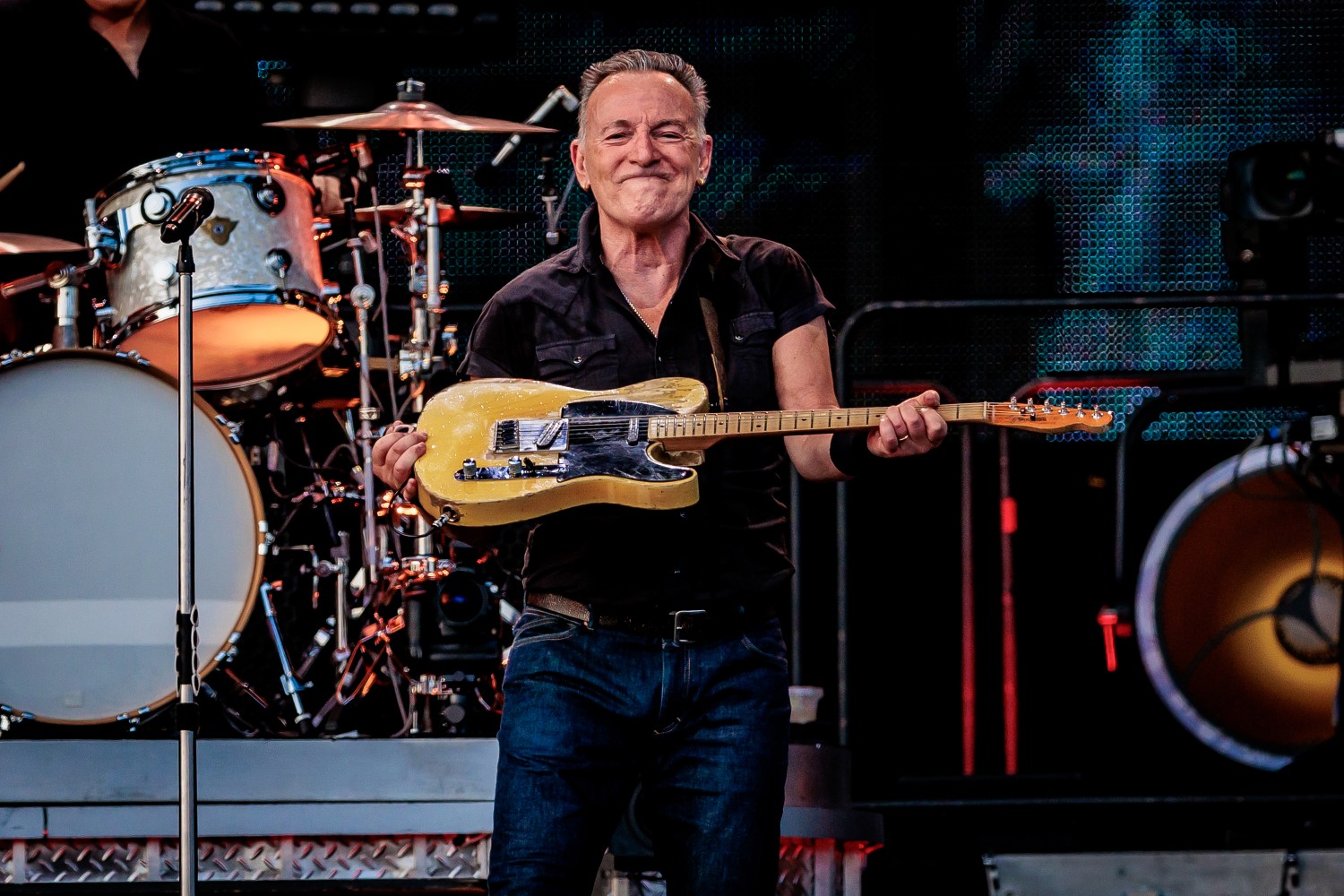Bruce Springsteen lifting a guitar on stage