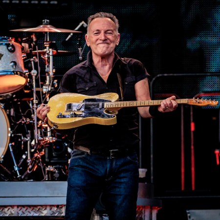 Bruce Springsteen lifting a guitar on stage