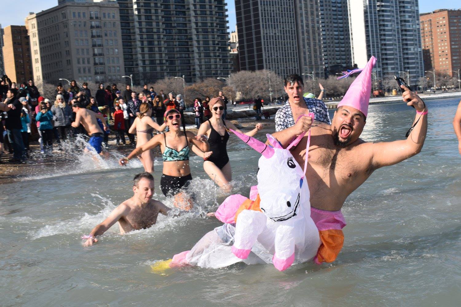 People running into the ocean