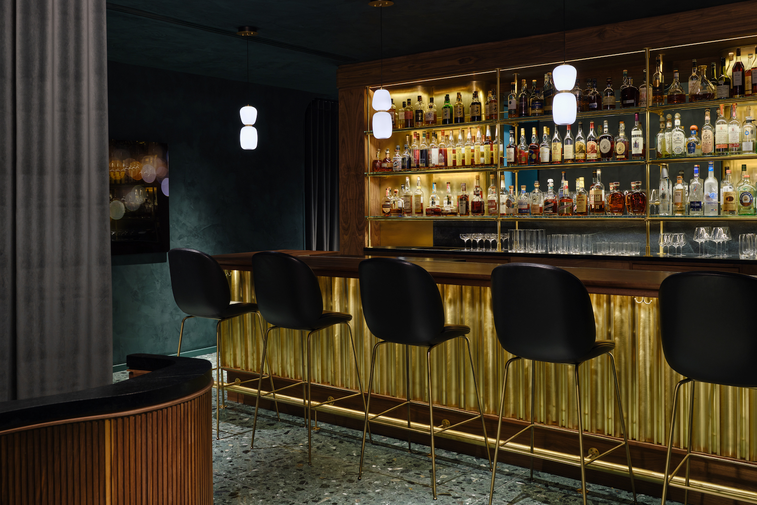 Interior of Providence's bar with gold-colored bar and blue-colored room in dim lights 
