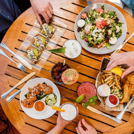 Birds-eye view of a table with plates of brunch food on it. Here are the best brunch spots in Malibu right now.
