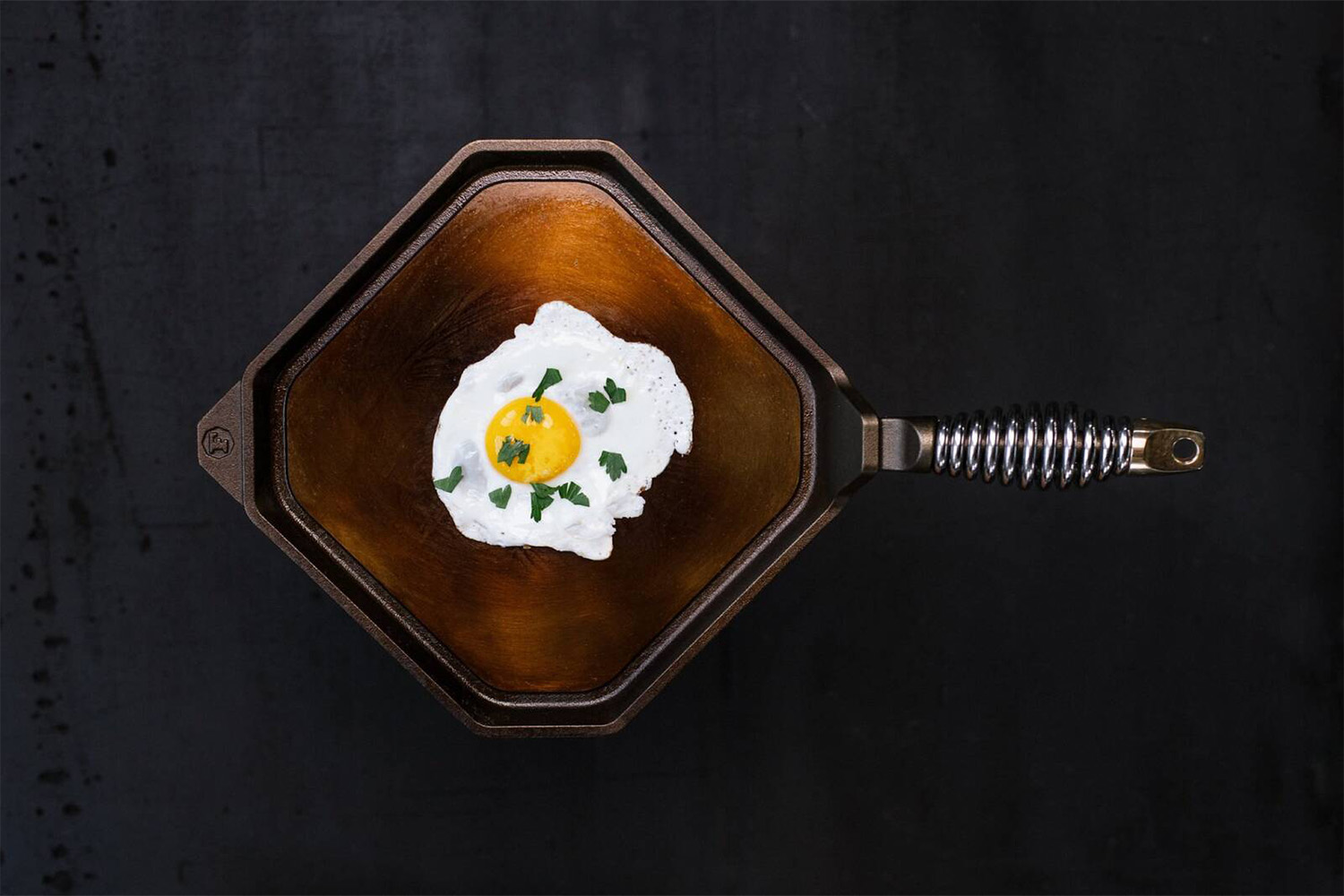 A Finex griddle cooking an egg.