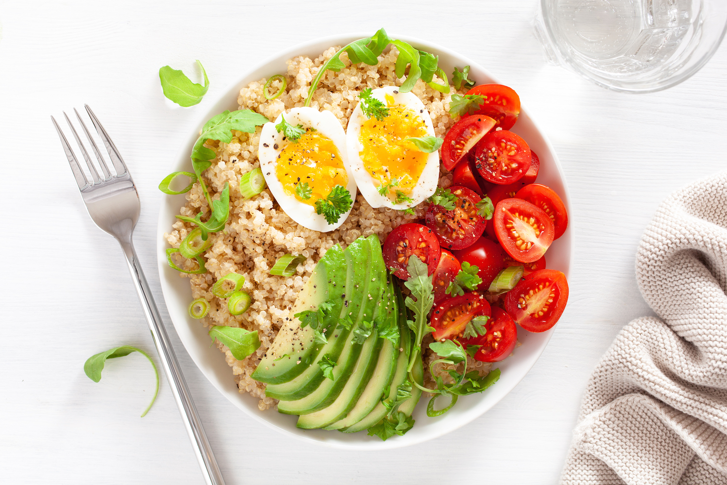 quinoa with boiled egg, avocado, tomato, arugula. healthy breakfast