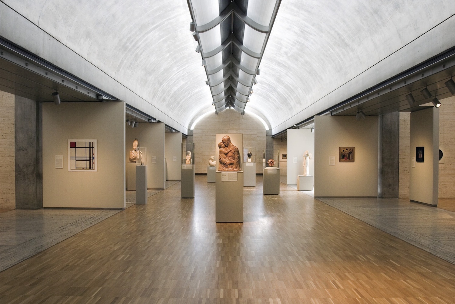 Interior of Kimbell Art Museum, with statues and posters on walls