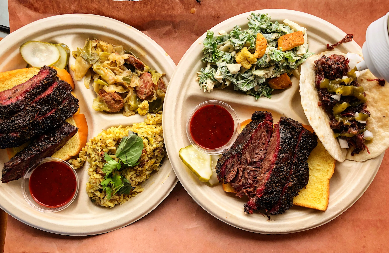 Plates with meat, bread, various salads and other sides