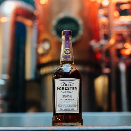 A bottle of the new Old Forester 1924 in front of a still