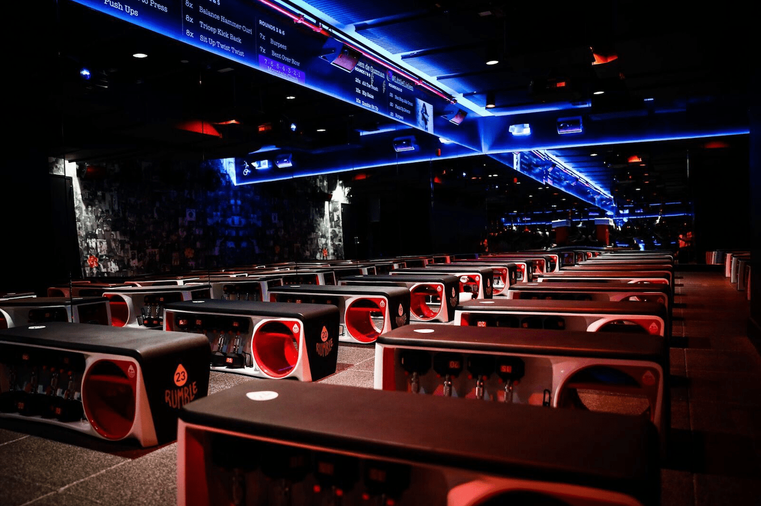 Interior of Rumble's studio, with workout equipment and club-like lighting 