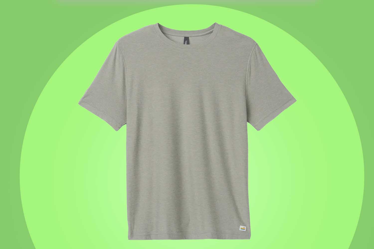 A Vuori's Strato Tech Tee on a green background