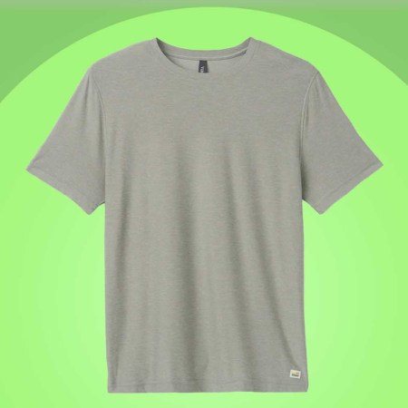 A Vuori's Strato Tech Tee on a green background