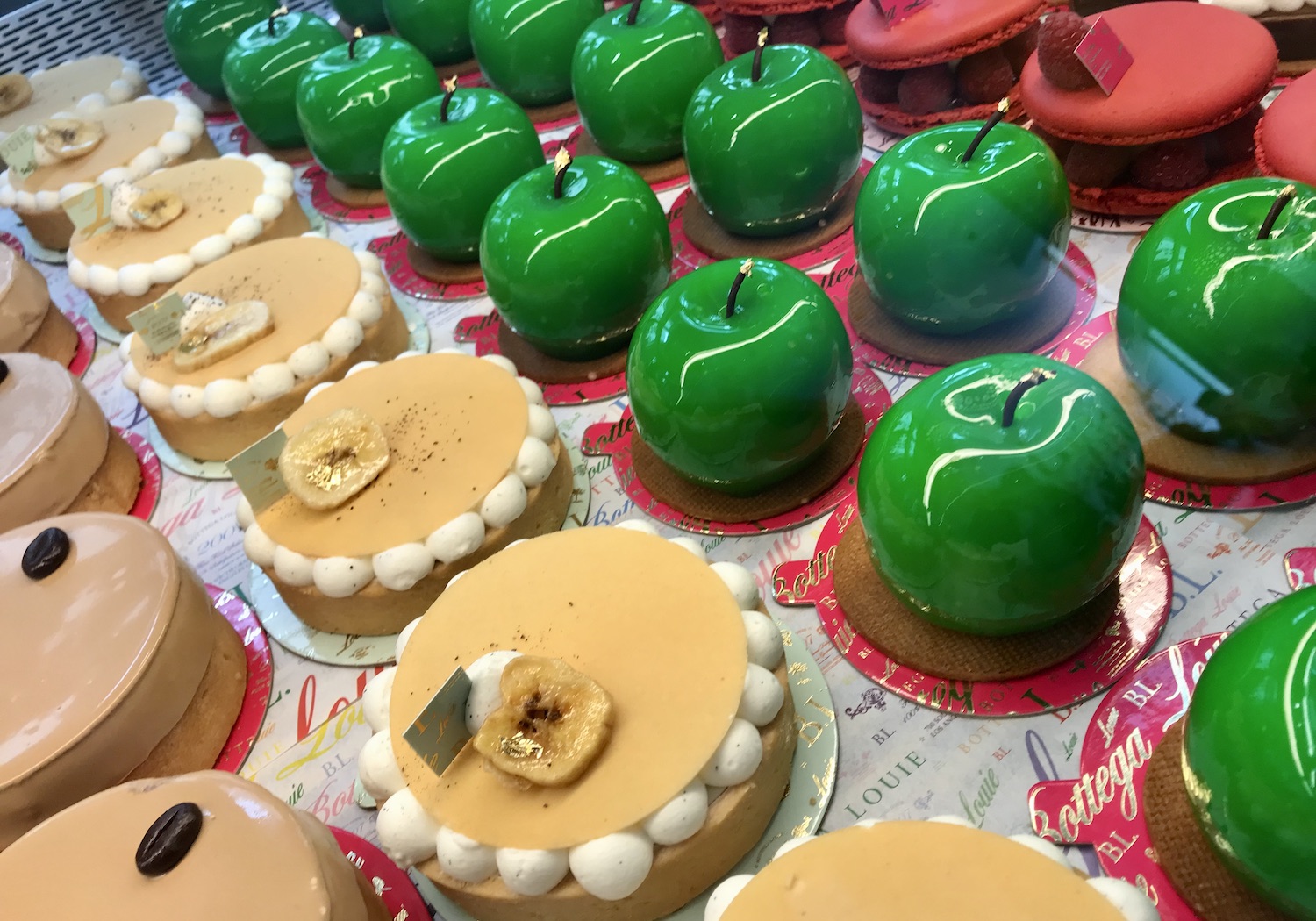 close-up of inside of a pastry case with different colored pastries