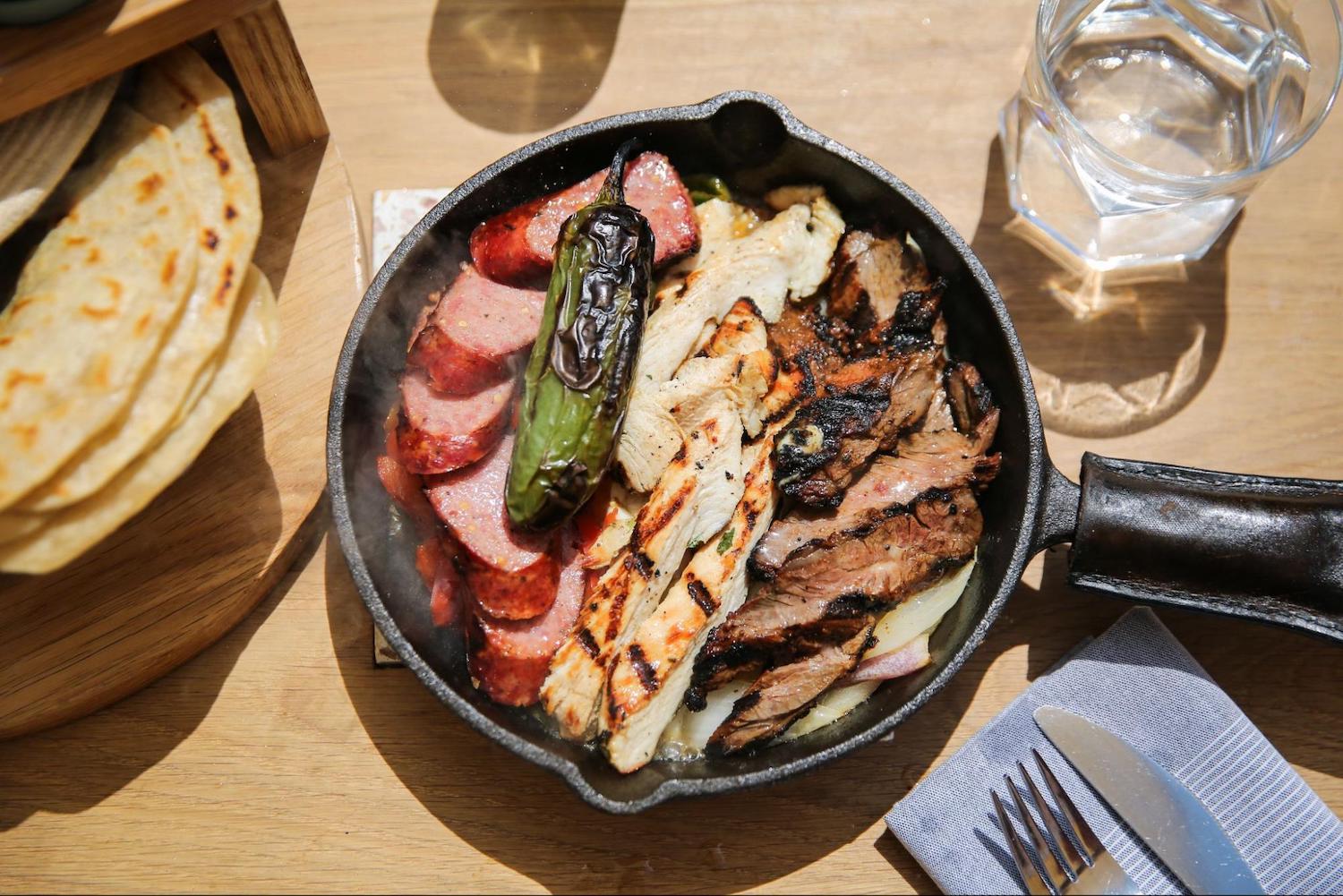 Cast iron skillet with food on a table