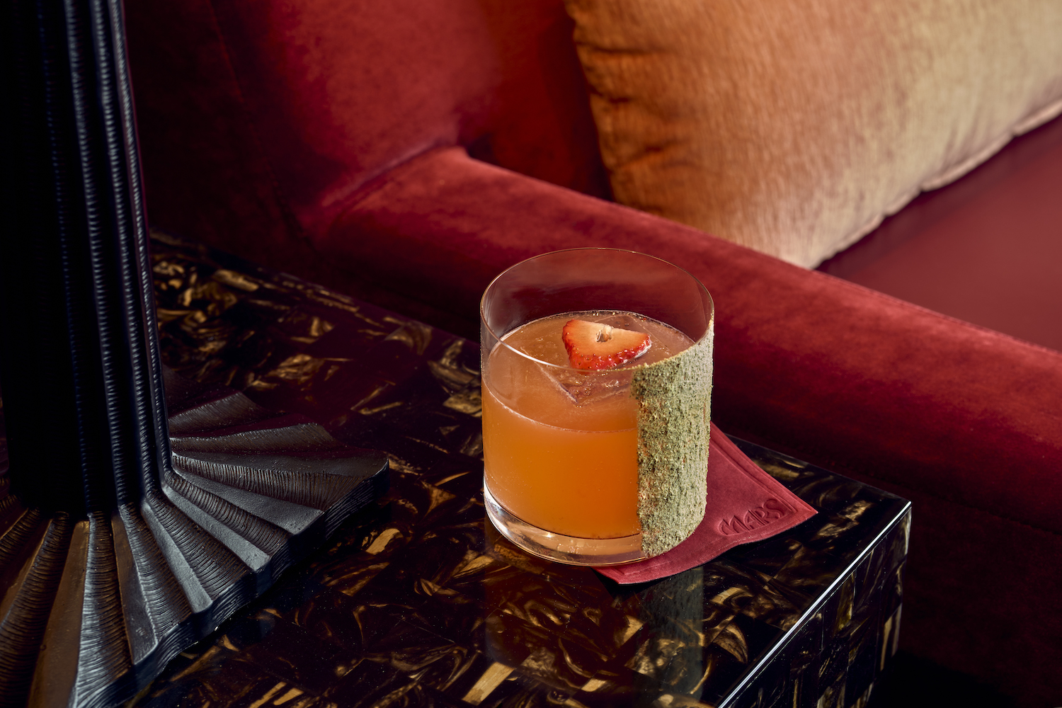 Mars Bar's Bellucci in a lowball glass on a dark-colored side table