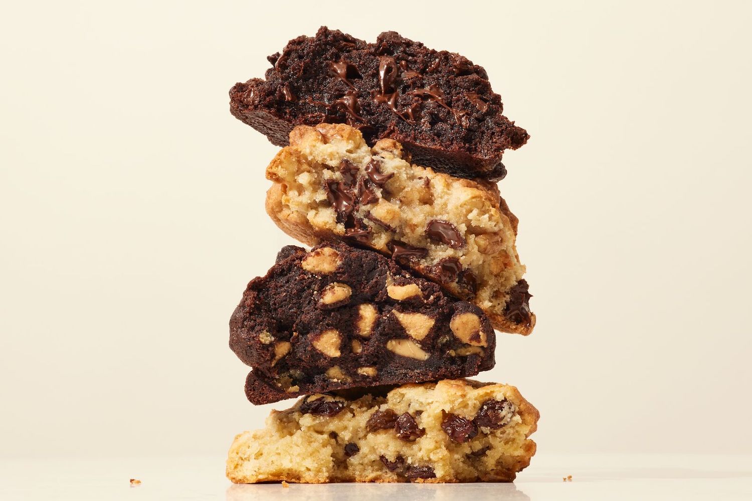 a stack of levain cookies on a tan background