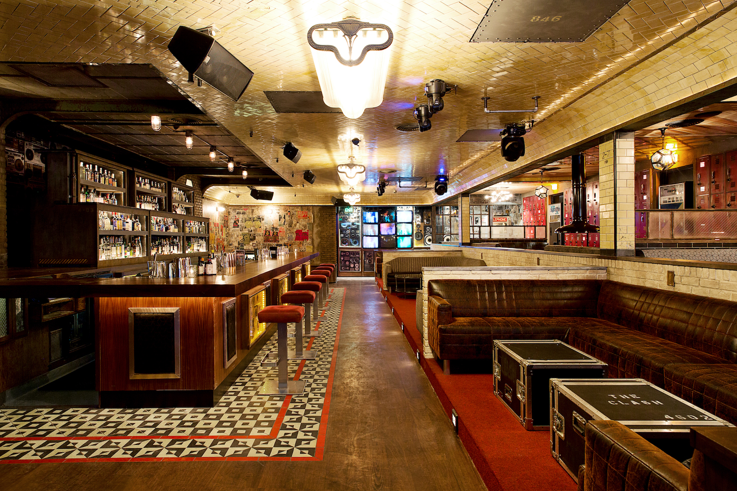Break Room 86 bar with checkered flooring, bar stools and dining area
