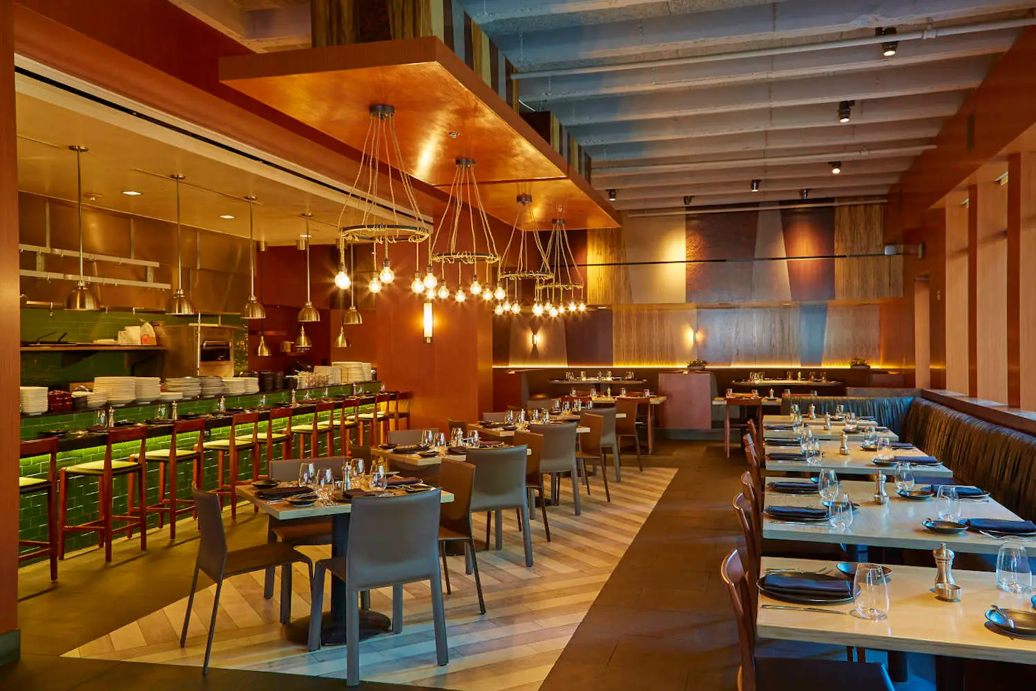 Interior of Knife with light wooden fixtures and green accents