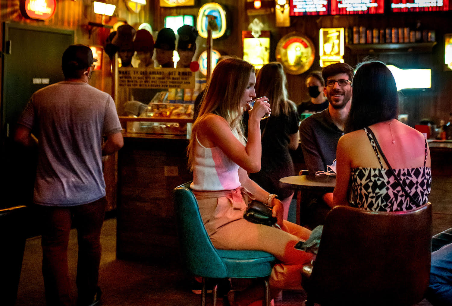 People sitting at high top table in bar area