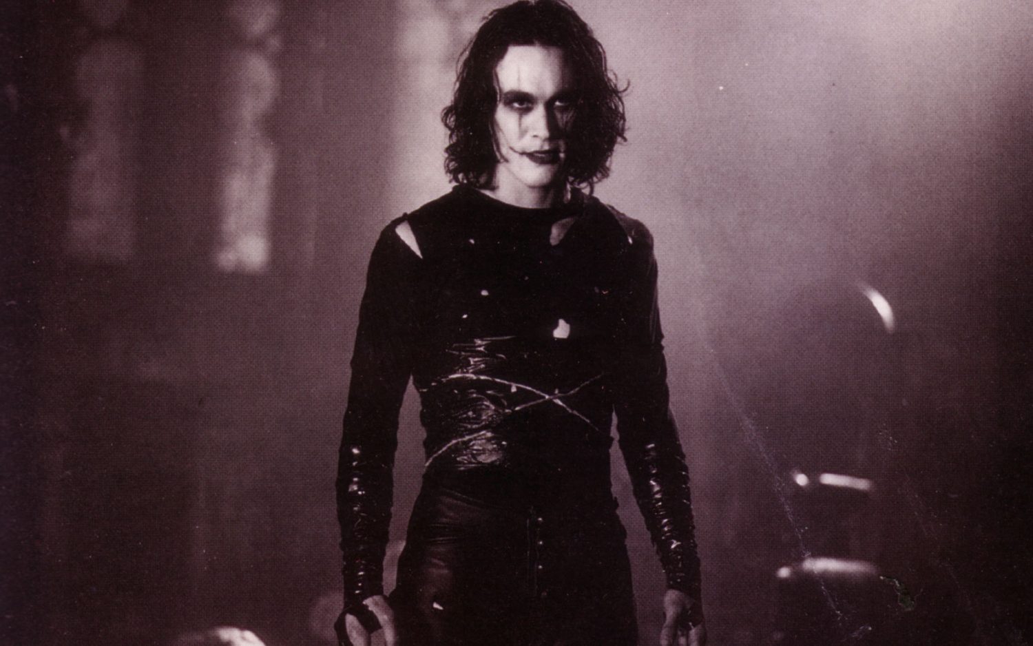 actor with black hair and white face makeup in black clothes
