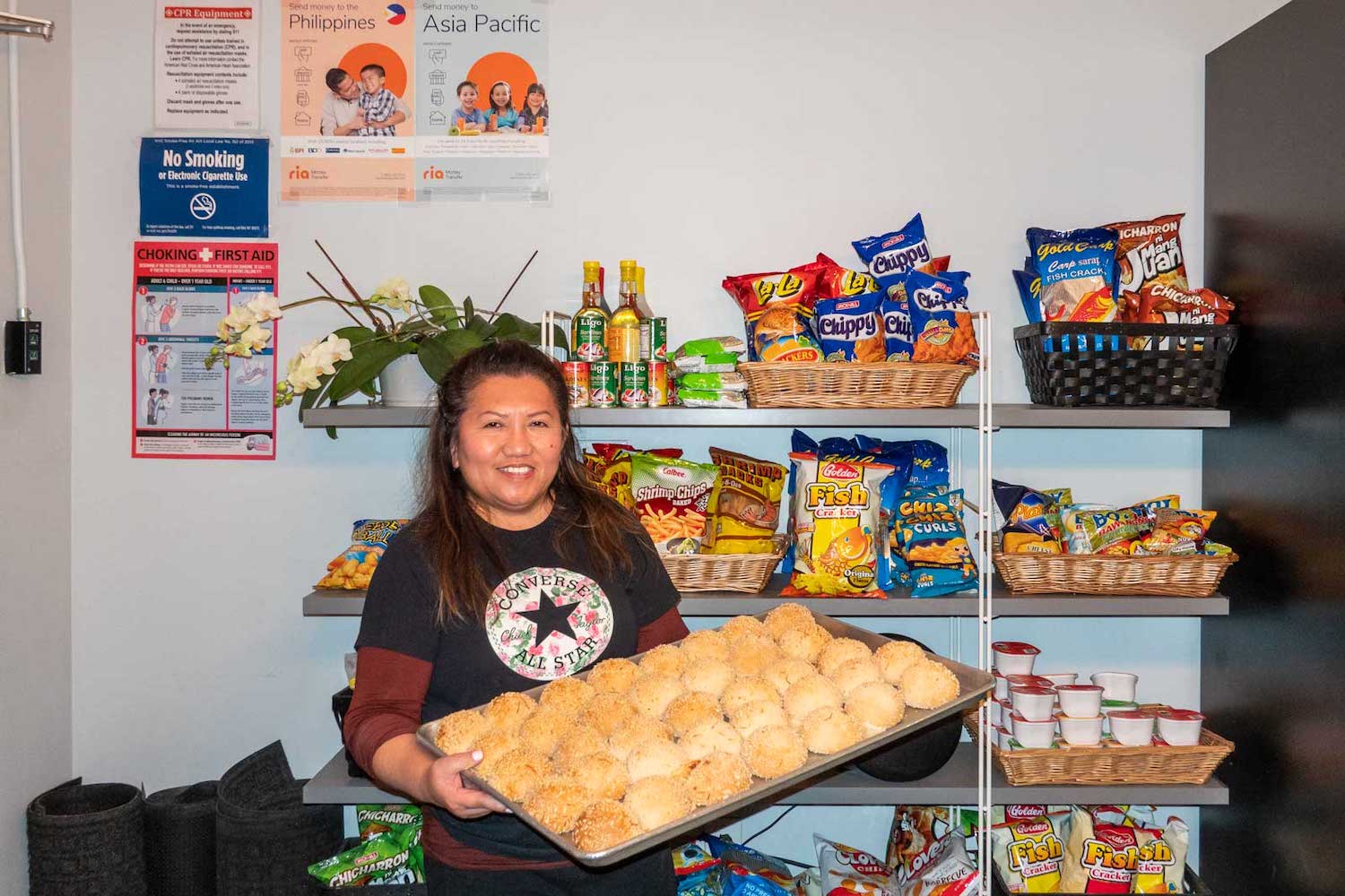 Nora Galleros of Kape't Torta poses with a tray of her cheese pandesal