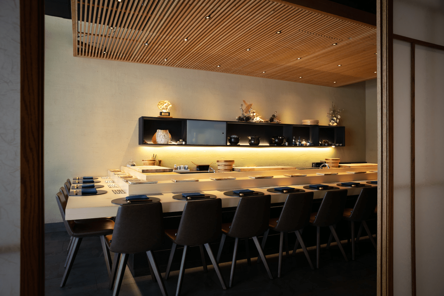 Long bar area with barstools and plates