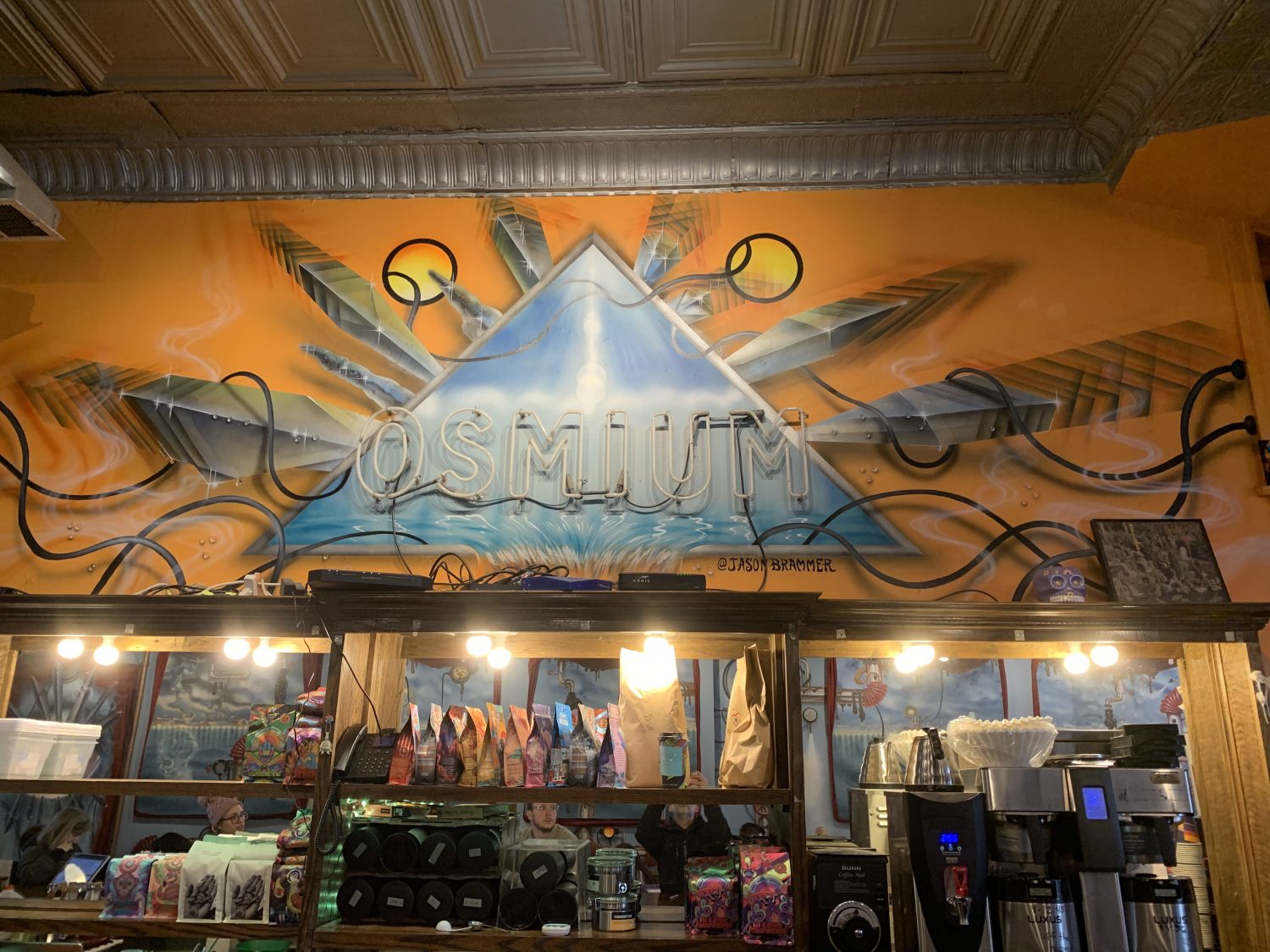Orange paint and sign with coffee bean bags and coffee machines