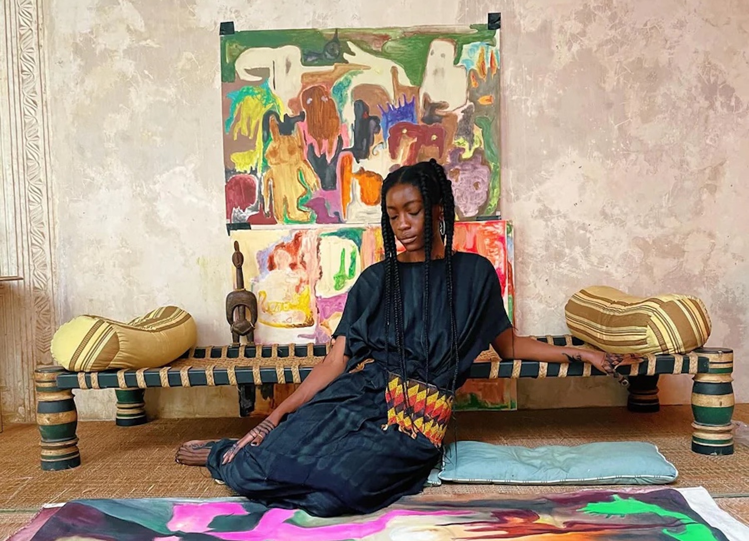 Artist Velma Rosai posing around art pieces