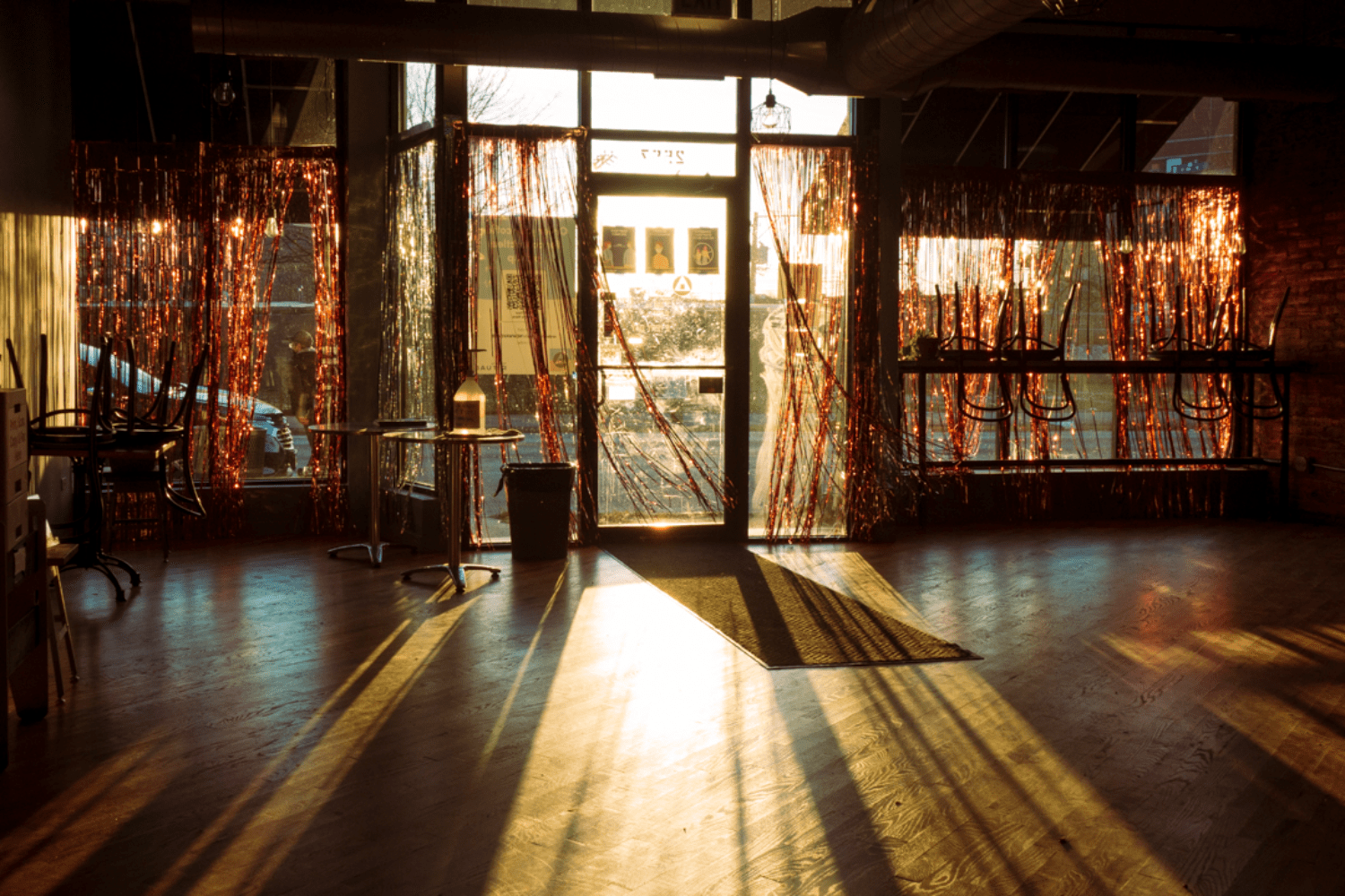 sunlight coming into dark room with red party streamers on windows 