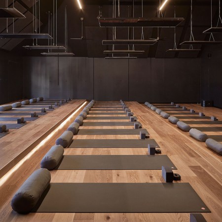 A hot yoga studio with empty mats. We look at what the science says about hot yoga's benefits, especially when it comes to depression.