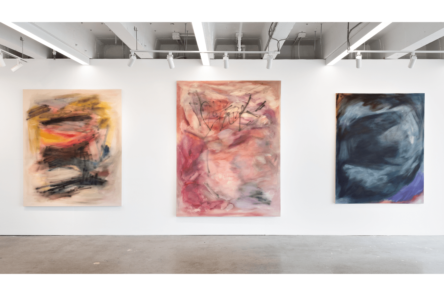 three large paintings, orange and yellow (left), pink (middle), dark blue and gray (right)