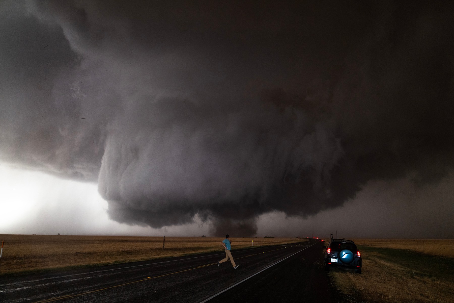 From this distance, you can see the entire structure. The problem is if you get a bit too close, you lose the view of the <a href="https://www.foxweather.com/learn/what-is-a-supercell-thunderstorm">supercel</a>l. It's pretty cool, because aside from the actual funnel hitting the ground, that next layer of cloud basically sort of goes through the middle of the image. That's what you call a wall cloud. That's always the first indication before a tornado drops and sometimes amateur storm chasers will mistake that for the tornado. Thankfully, there was no damage. Most tornadoes I've witnessed landed in open empty fields.