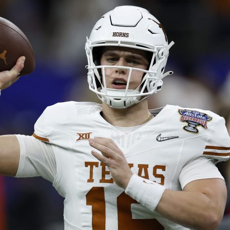 Arch Manning of the Texas Longhorns warms up prior to playing.