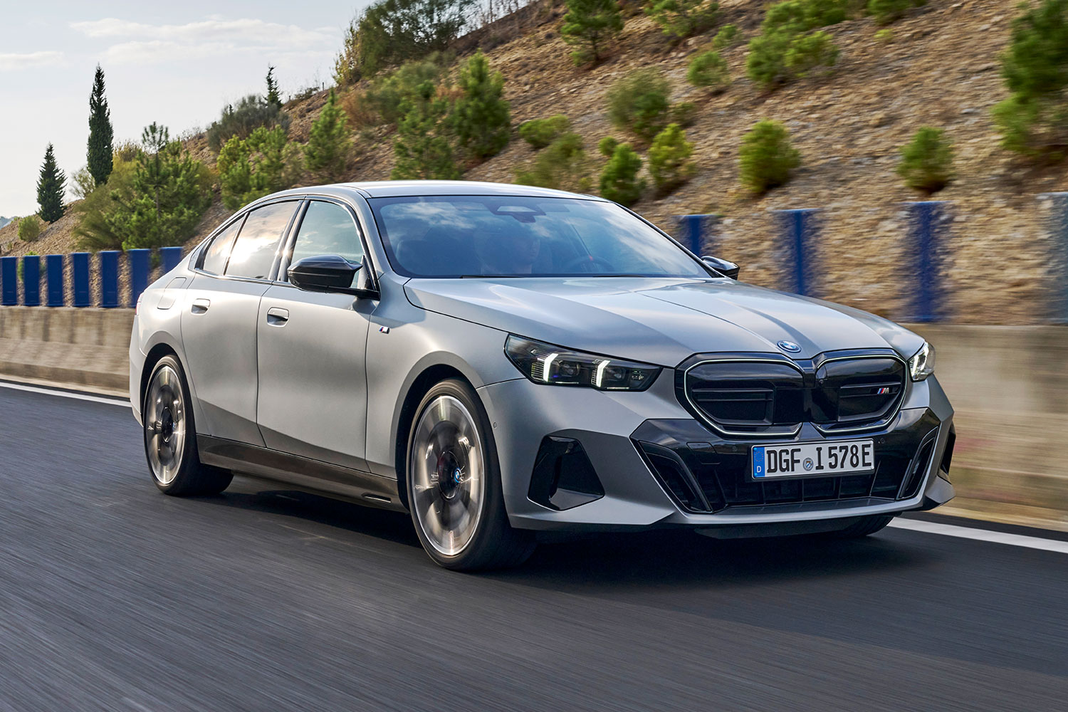 The 2024 BMW i5 M60 electric sedan driving down the road