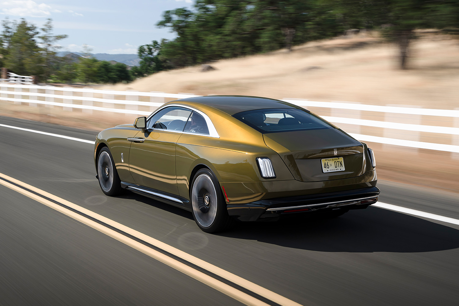 The rear end of the Spectre electric car as it drives down the road