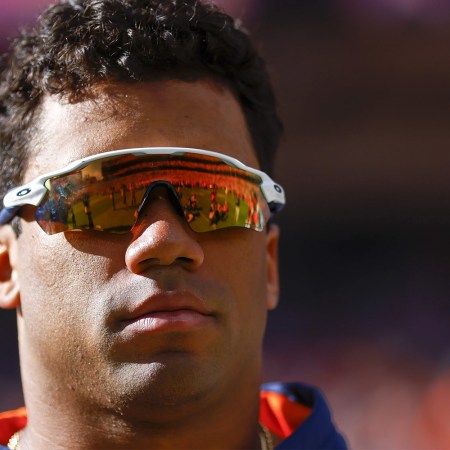 Russell Wilson of the Denver Broncos watches his team warm up. Will cutting him help the Broncos cure their eight-year Super Bowl hangover?