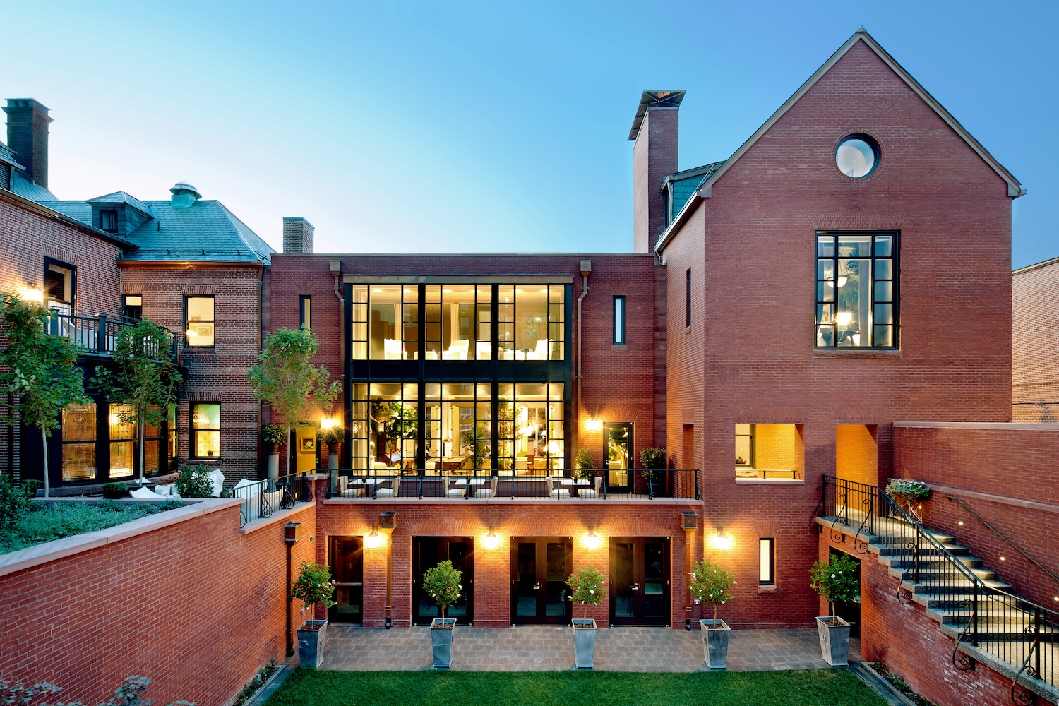 outside of hotel, brick, large windows, trees and grass