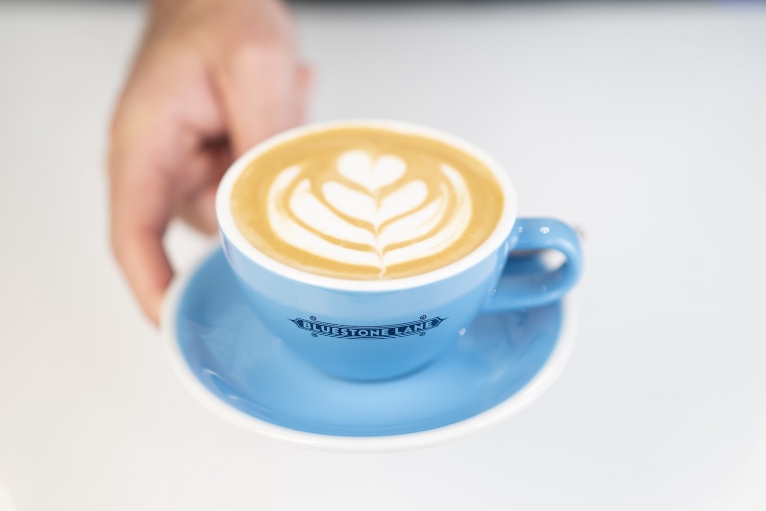 cafe latte in a blue cup with blue plate