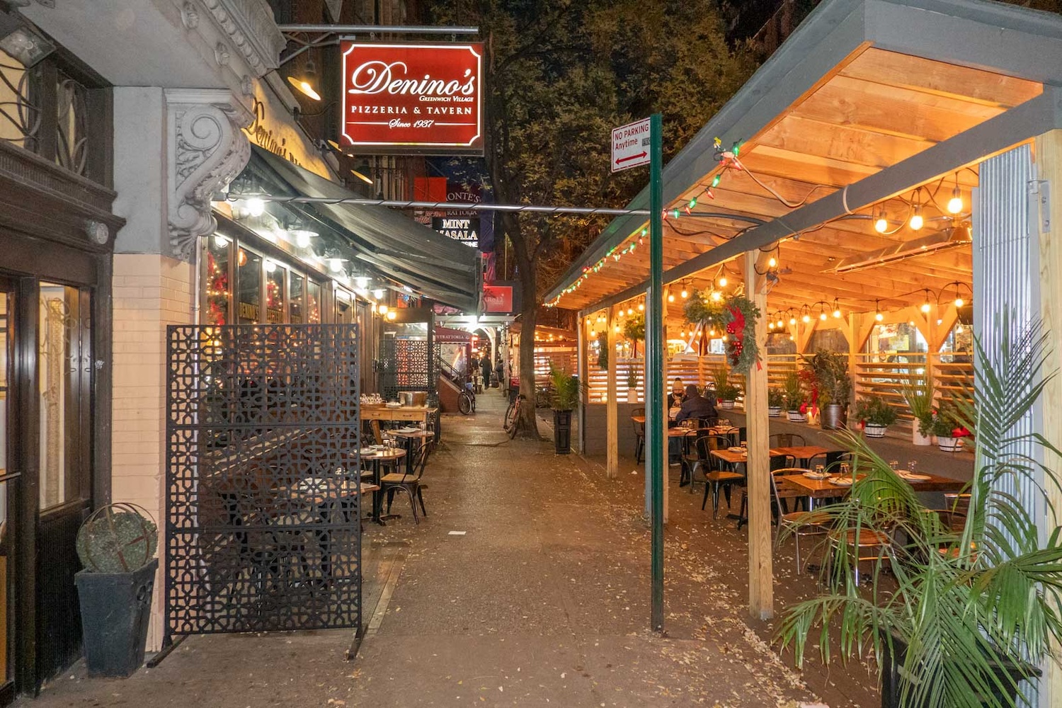 outdoor restaurant, lights, chairs, sign, street, street signs