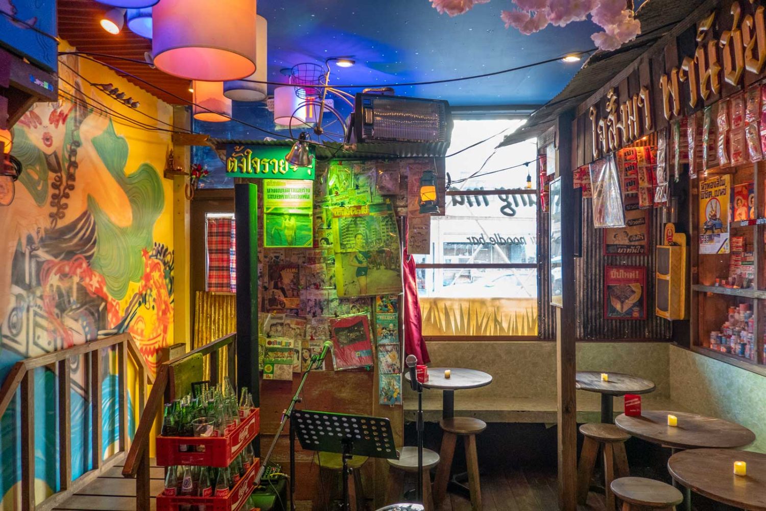 multicolored room, lamps, signs, chairs, tables, plants