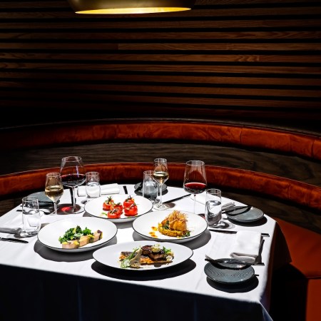 plates of food, wine glasses, burgundy booth