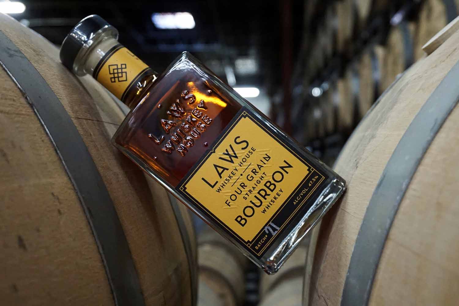 bourbon from Laws Whiskey House resting on two barrels