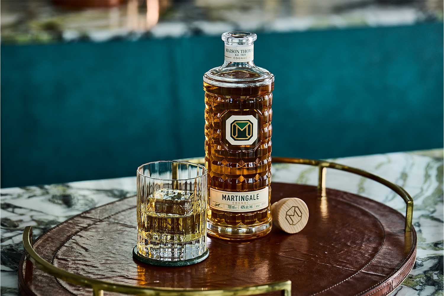A bottle and glass of Martingale Cognac on a table