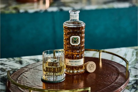 A bottle and glass of Martingale Cognac on a table