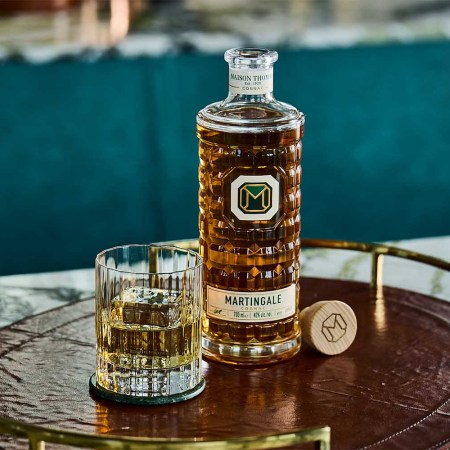 A bottle and glass of Martingale Cognac on a table