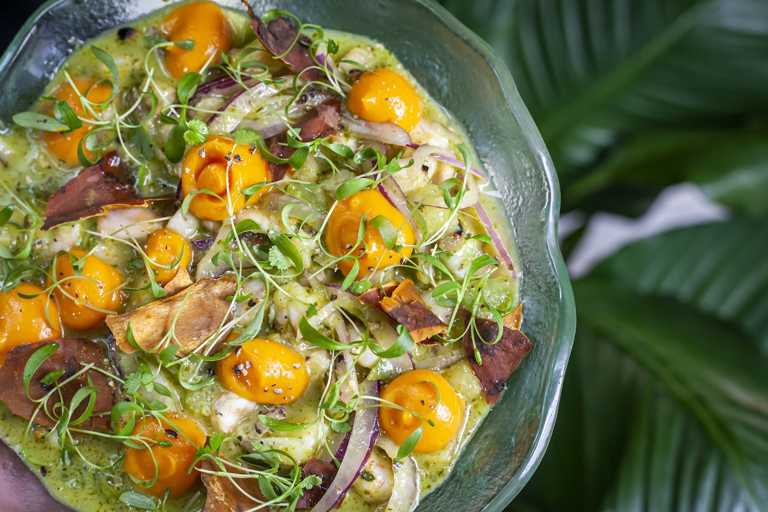 guacamole with special ingredients (yellow fruit, garnish)
