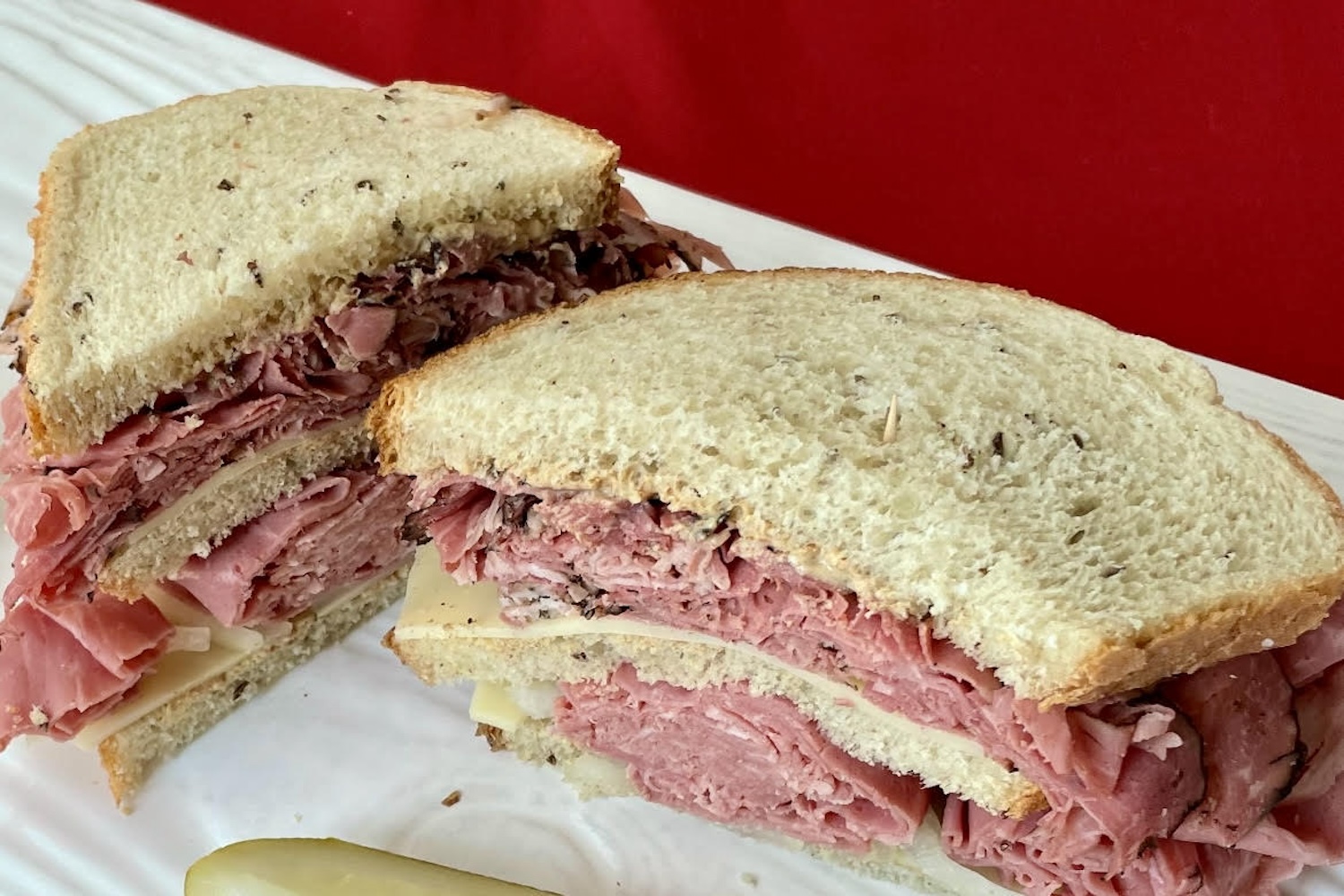 meat sandwich, pickle on side